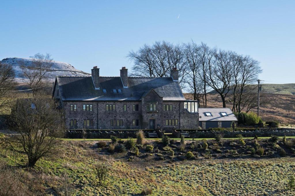 an old house on top of a hill at Oakenclough Hall in Macclesfield