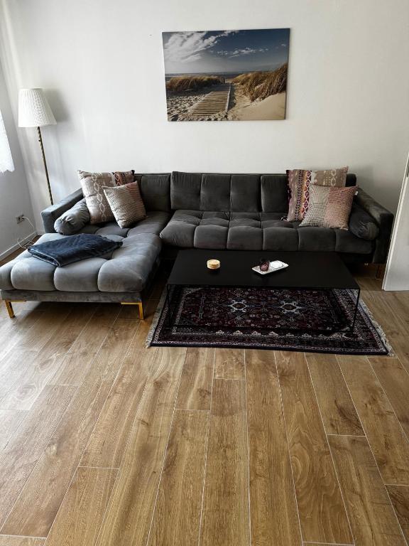 a living room with a leather couch and wooden floors at Karla in Torgelow