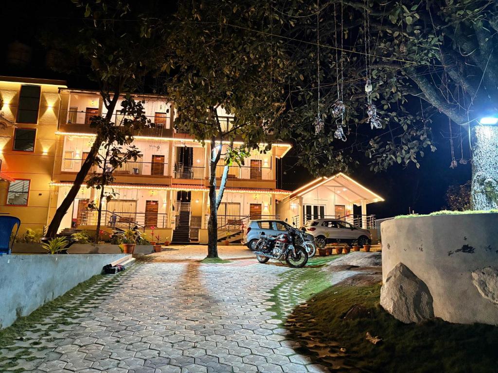 a motorcycle parked in front of a building at night at Riverside Resort Yelagiri in Yelagiri