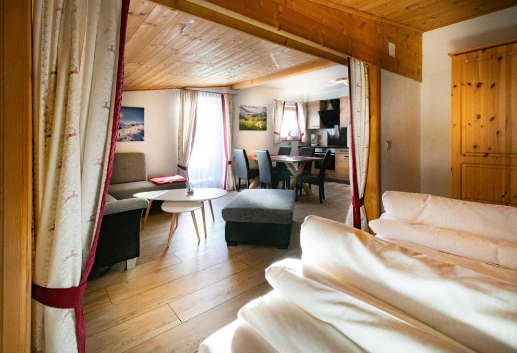a room with two beds and a living room at Apartment Morgensonne in Piesendorf