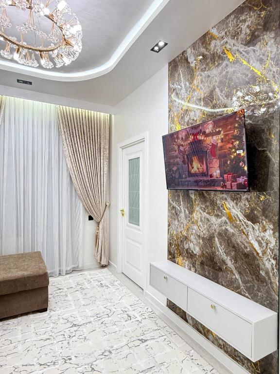 a living room with a large marble wall at Modern Luxury Apartment Central Samarkand in Samarkand