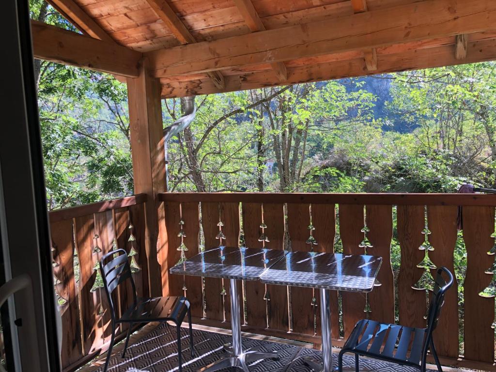 a table on a screened in porch with chairs at T2 tout confort Ax les thermes in Ax-les-Thermes
