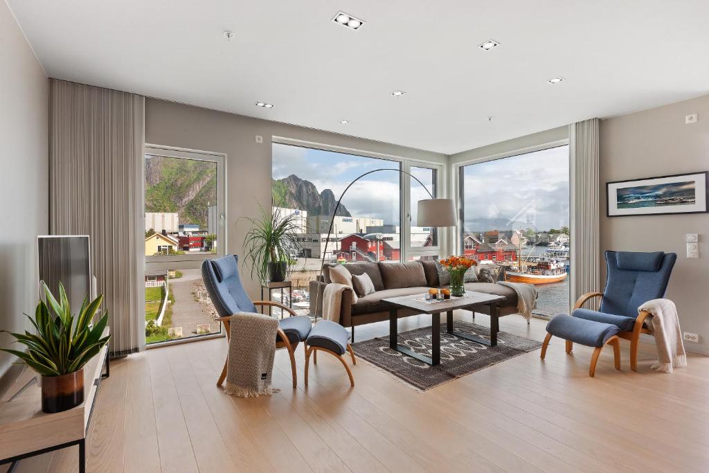 a living room with a couch and a table and chairs at Svolvær Panorama City Suite in Svolvær