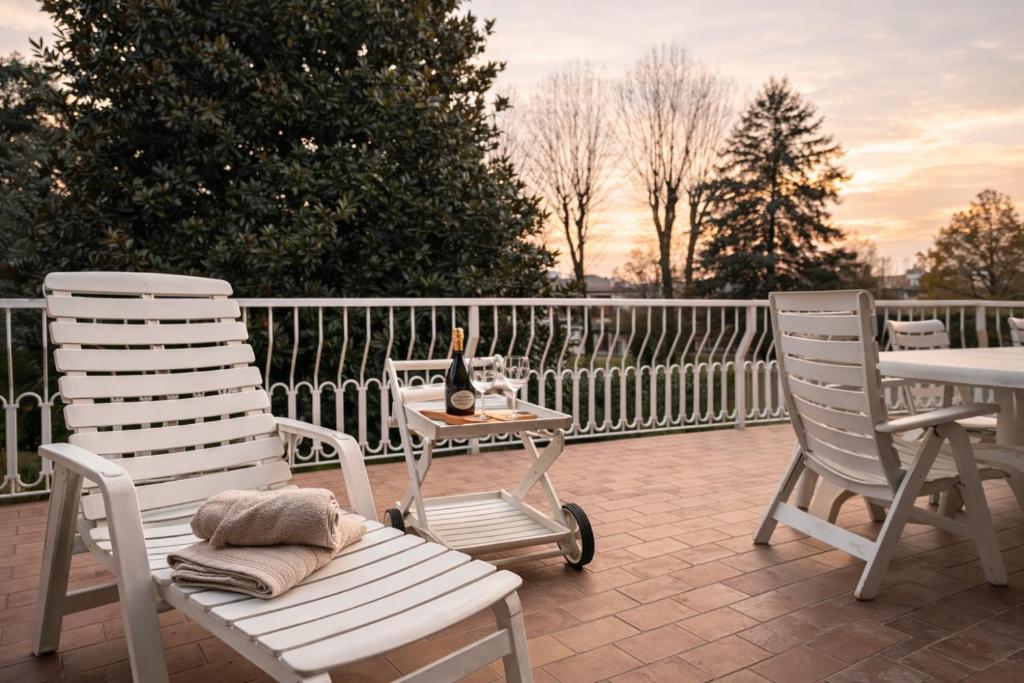 a patio with two chairs and a table with a bottle of champagne at Villa Magnolia in Vicenza