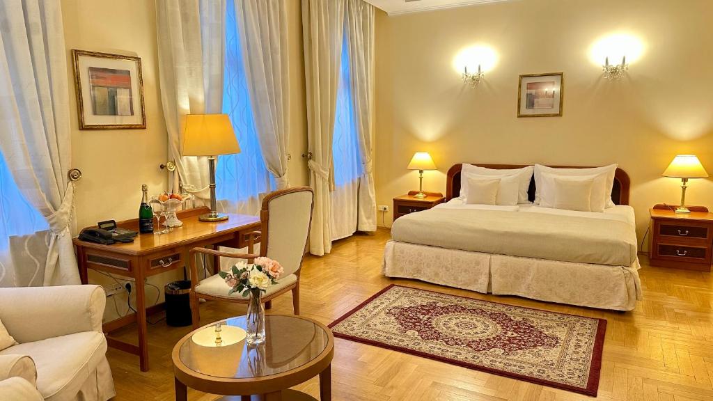 a bedroom with a bed and a living room at FLEUR DE LIS HOTEL in Prague