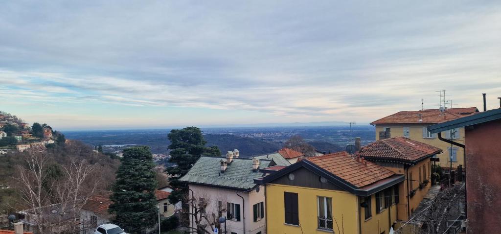 a view of a city with houses and trees at Brunate Funicolare Apartament in Brunate