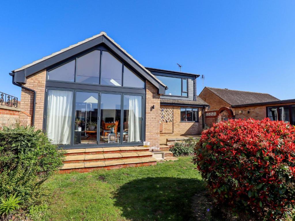 a house with a large window on the side of it at Seascape in Hunstanton