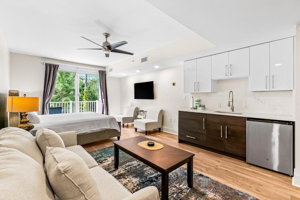 a living room with a couch and a bed and a kitchen at Lasata #3112 in Destin