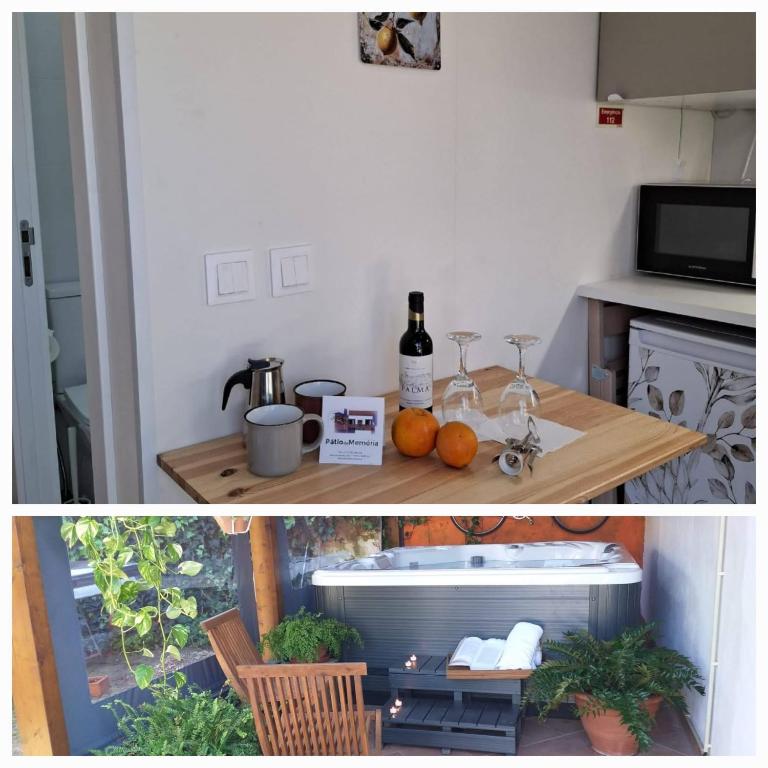 a kitchen with a table with a bottle of wine at Páteo da Memória Casa do Pintor in Quinta do Anjo
