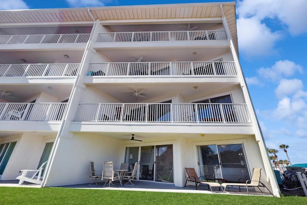 a white apartment building with chairs and a balcony at Maravilla 1114 in Destin