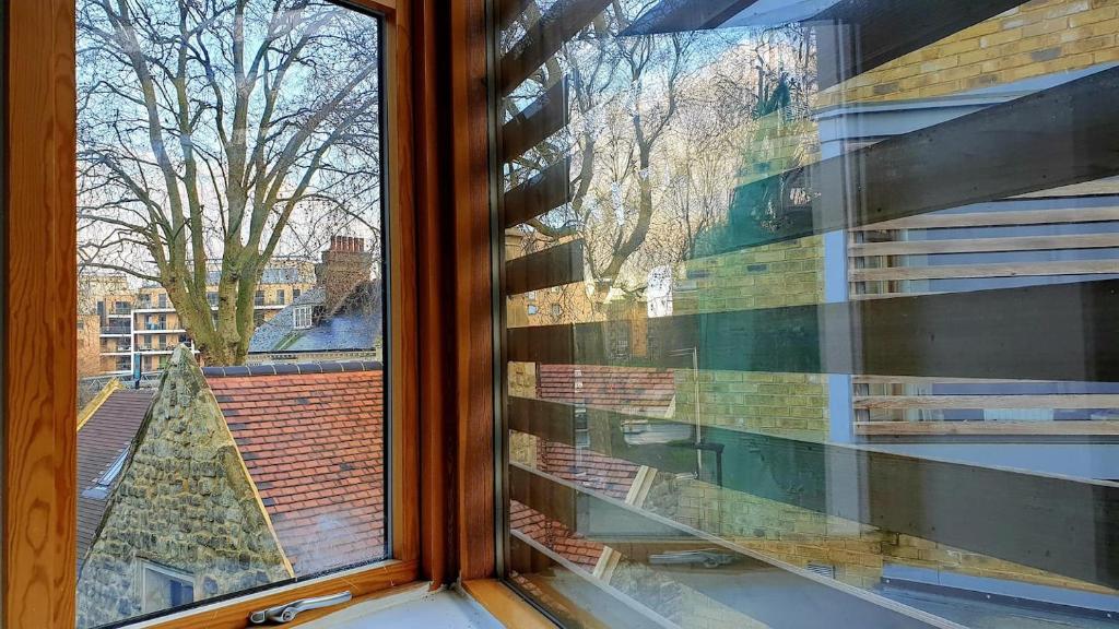 a window with a view of a christmas tree at Superb Guest Room in London