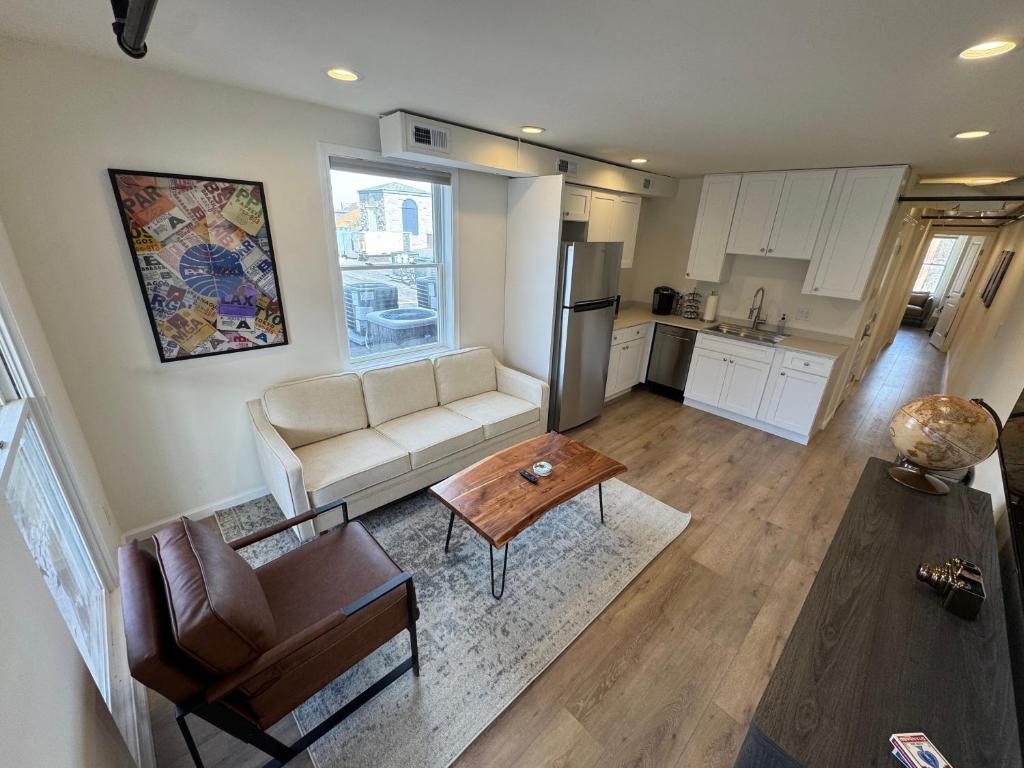 a living room with a couch and a table at The Global Getaway in St. Charles