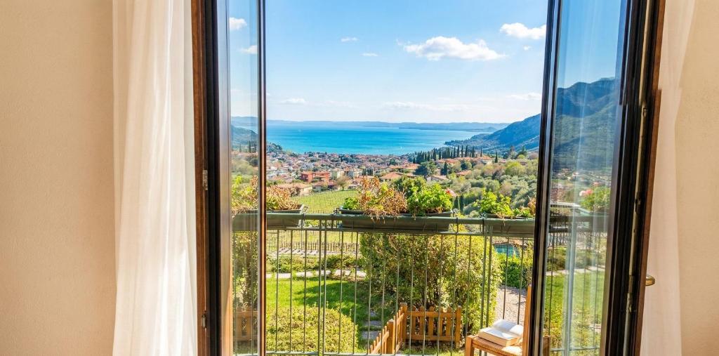 a window with a view of a city at Appartamenti Vista Lago - Costermano sul Garda - Be Happy! in Costermano sul garda