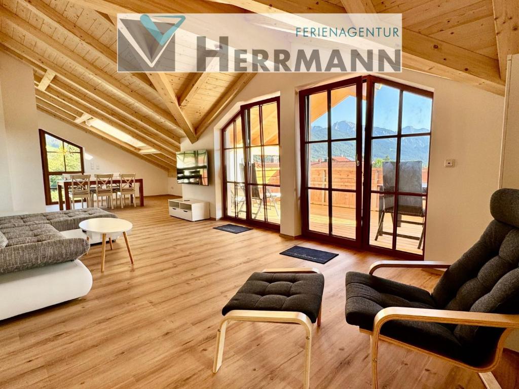 a living room with a couch and chairs and windows at Ferienwohnung Weitsicht in Halblech