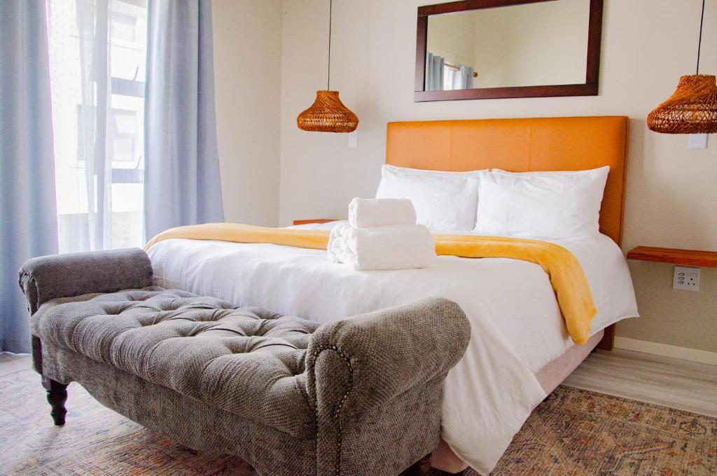 a bedroom with a large bed and a couch at Rustic Hills No 3 Self Catering in Swakopmund