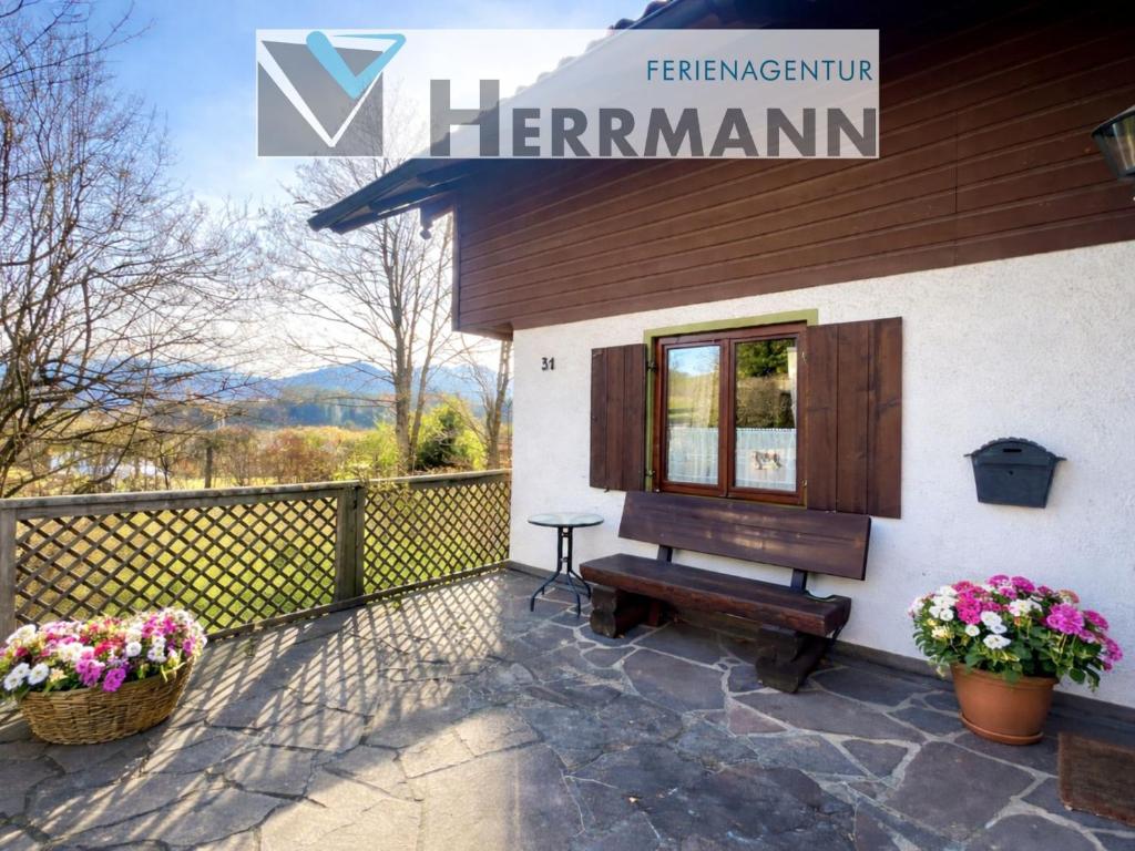 a house with a piano next to a fence at Ferienhaus Faulensee in Rieden