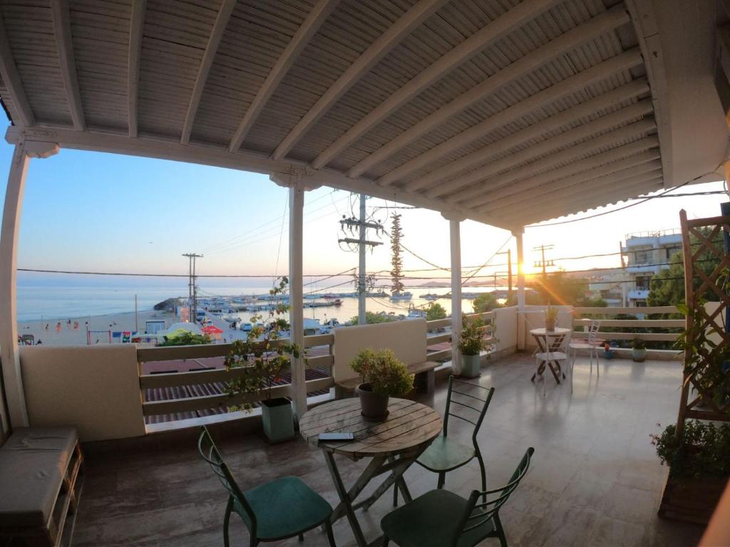 a patio with a table and chairs and the ocean at SEA VIEW in Nea Skioni