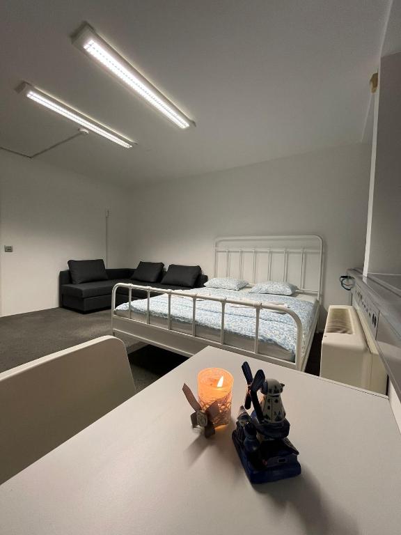 a room with a bed and a table with a candle at COliving RD6 in Ljubljana