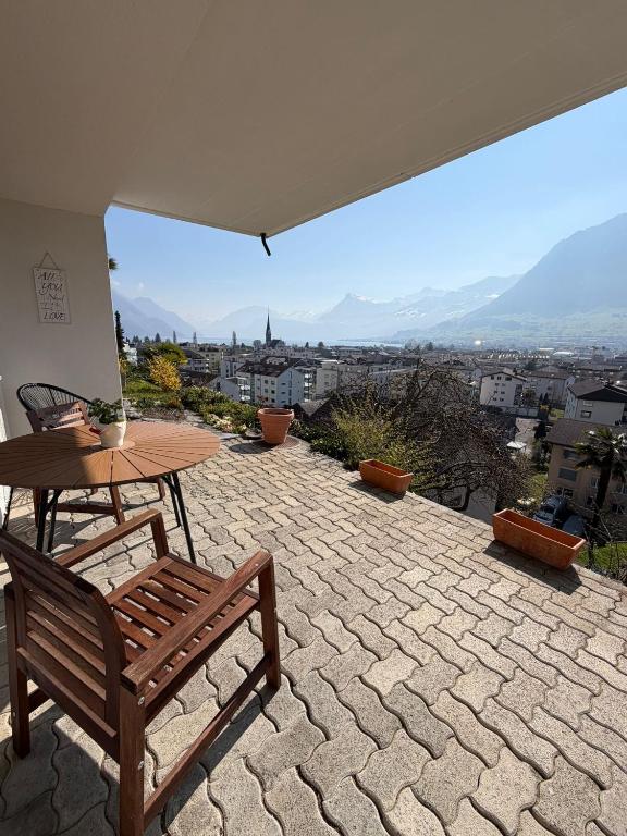 a patio with a table and a bench and a view at Studio Lakeview in Ennetbürgen
