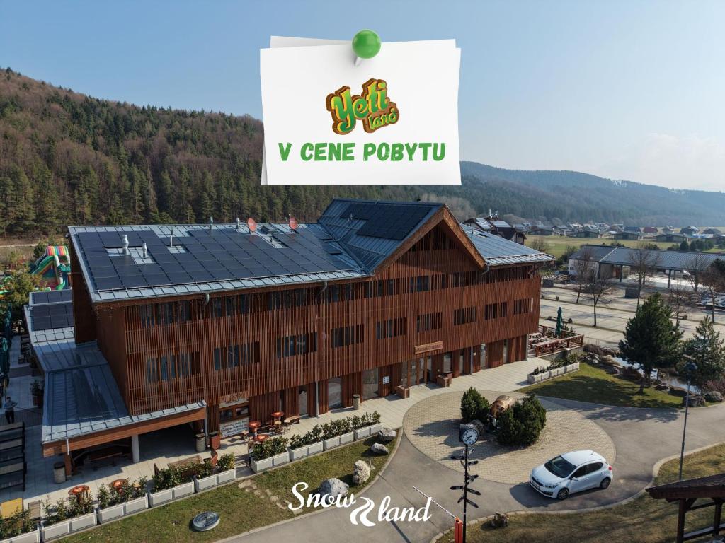 a large building with solar panels on the roof at Apartmány Humno in Stará Turá