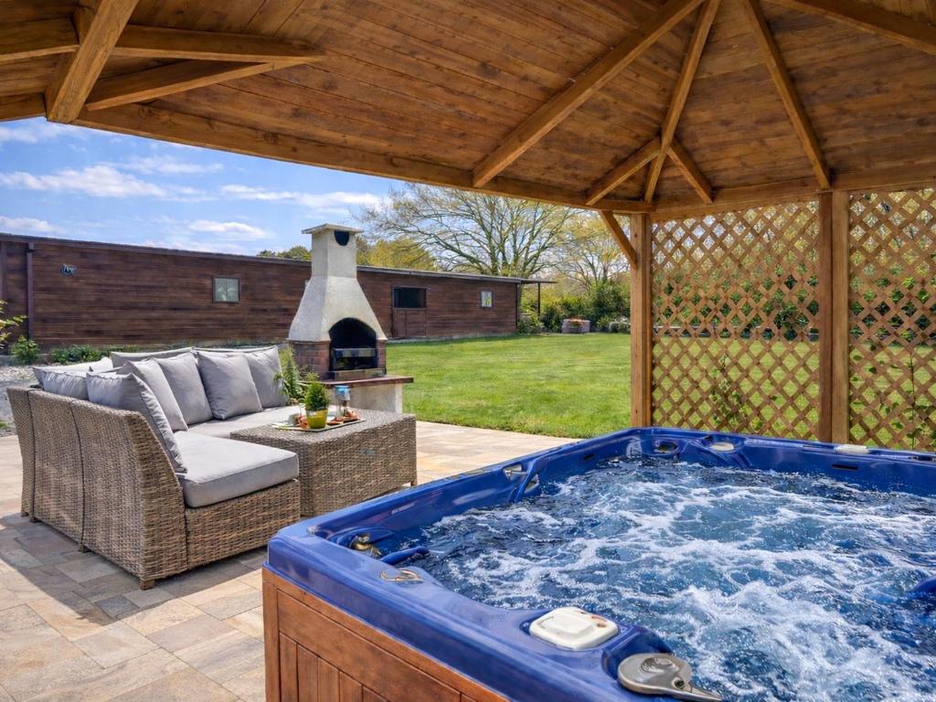 a large jacuzzi tub in a pavilion at Egmont Farmhouse in Newenden