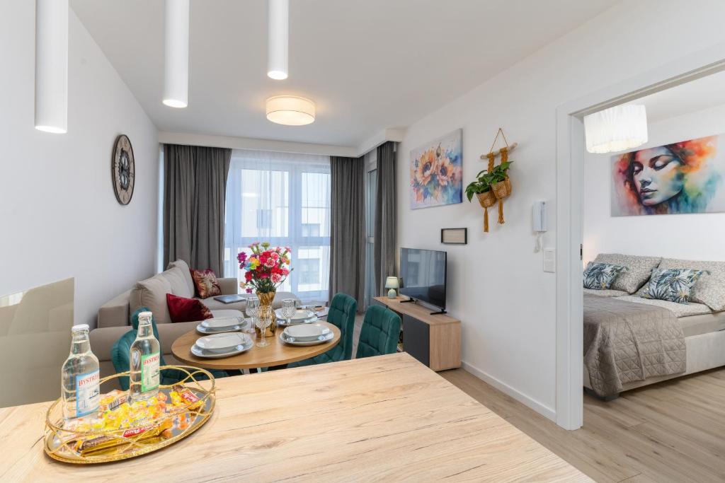 a living room with a couch and a table at Apartament Sun&City in Bielsko-Biała