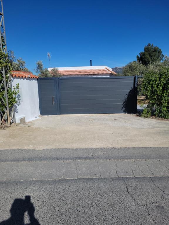 a shadow of a person standing in front of a garage at Alojamiento GUADALENTIN in Pozo Alcón
