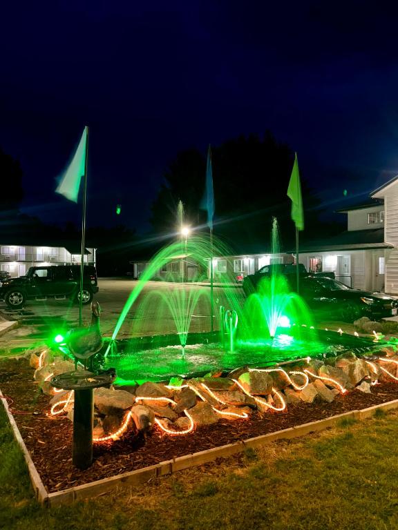 a fountain with green lights in a parking lot at Rainbow INN in Terrace
