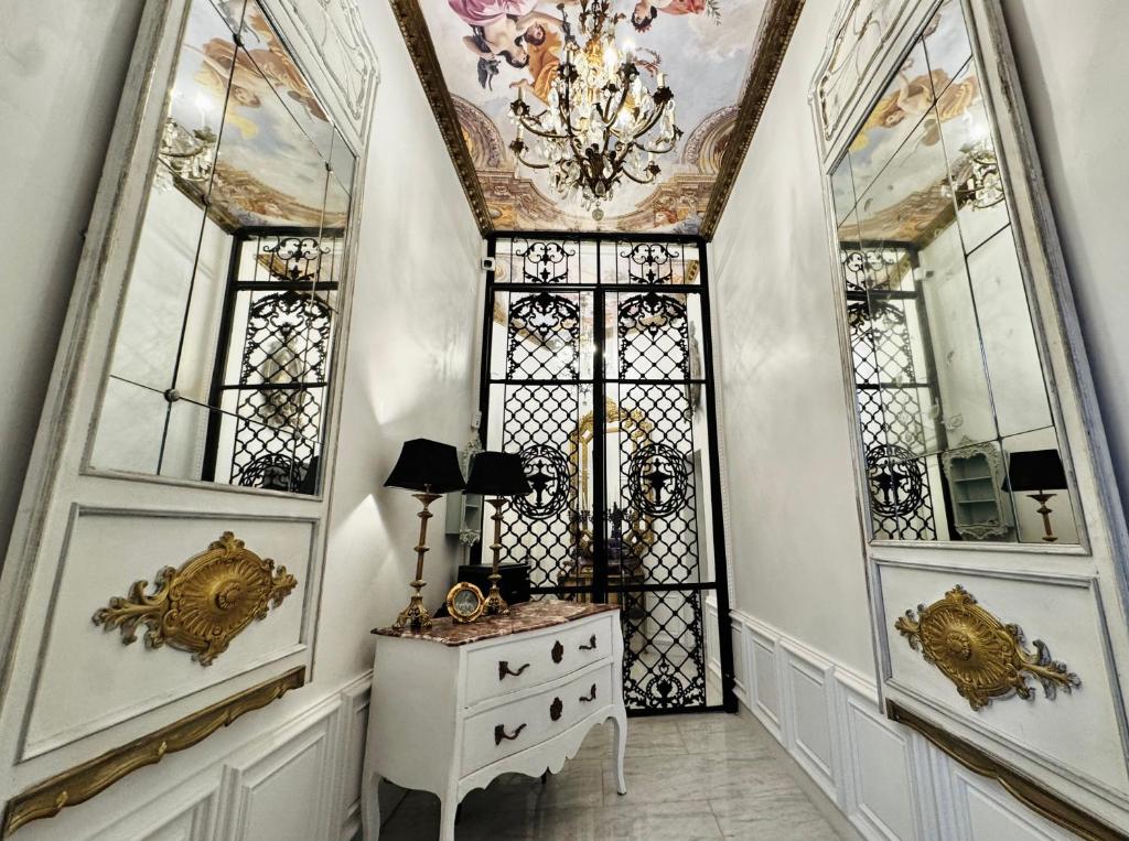 a room with a dresser and a chandelier at Chateau D'Amour Luxury Boutique in Bucharest