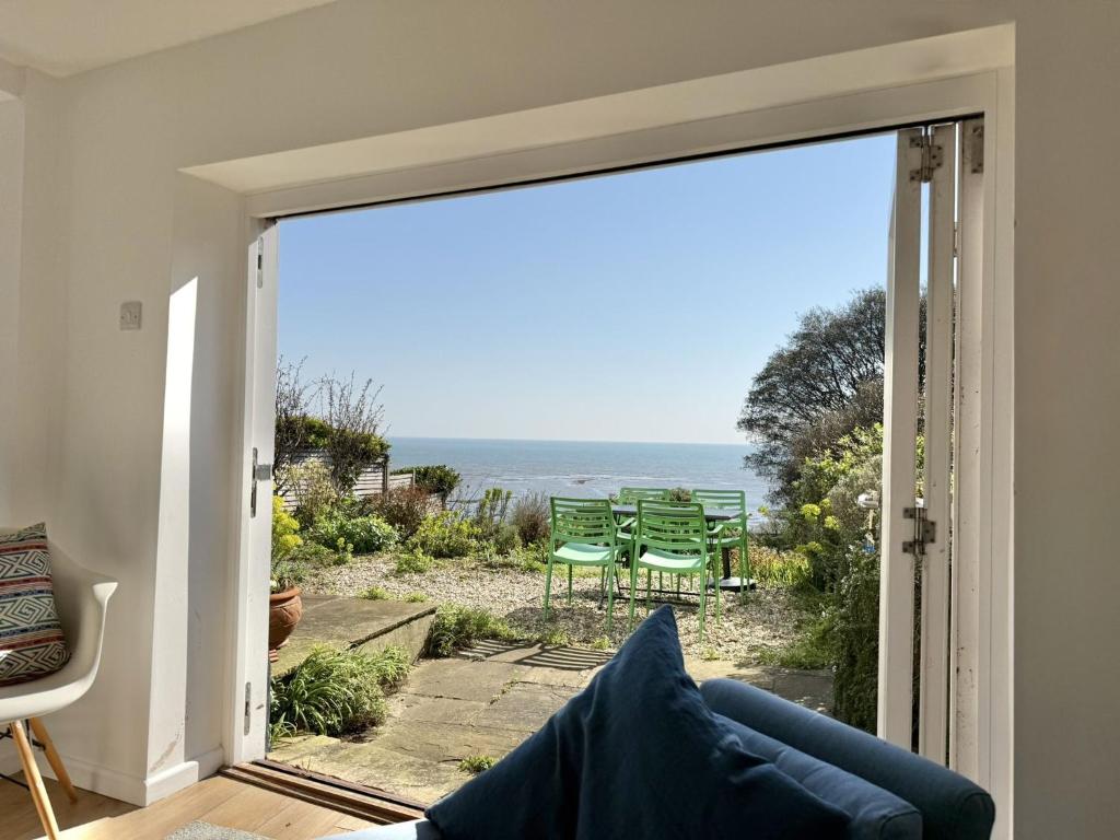 a living room with a view of the ocean at 1 East Cliff in Lyme Regis