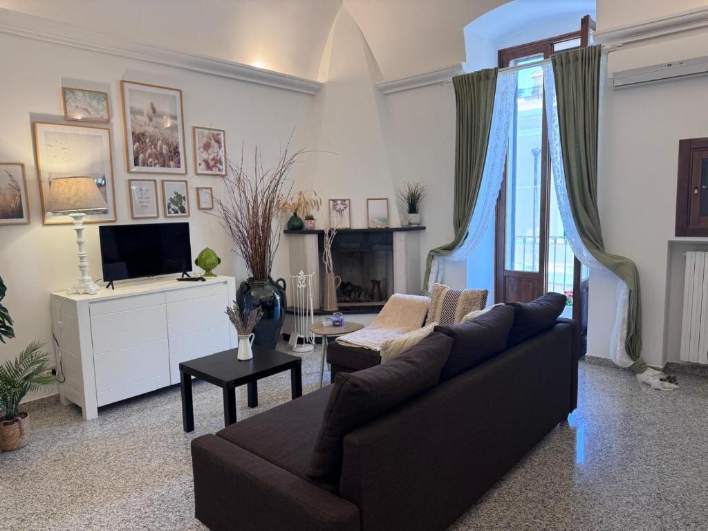 a living room with a couch and a tv at C'era Una Volta in Monopoli