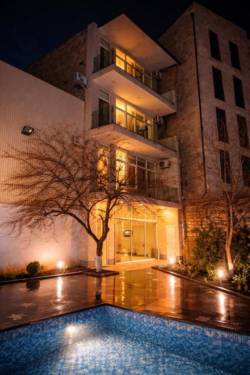 a building with a swimming pool in front of a building at Wave Inn boutique in Yerevan