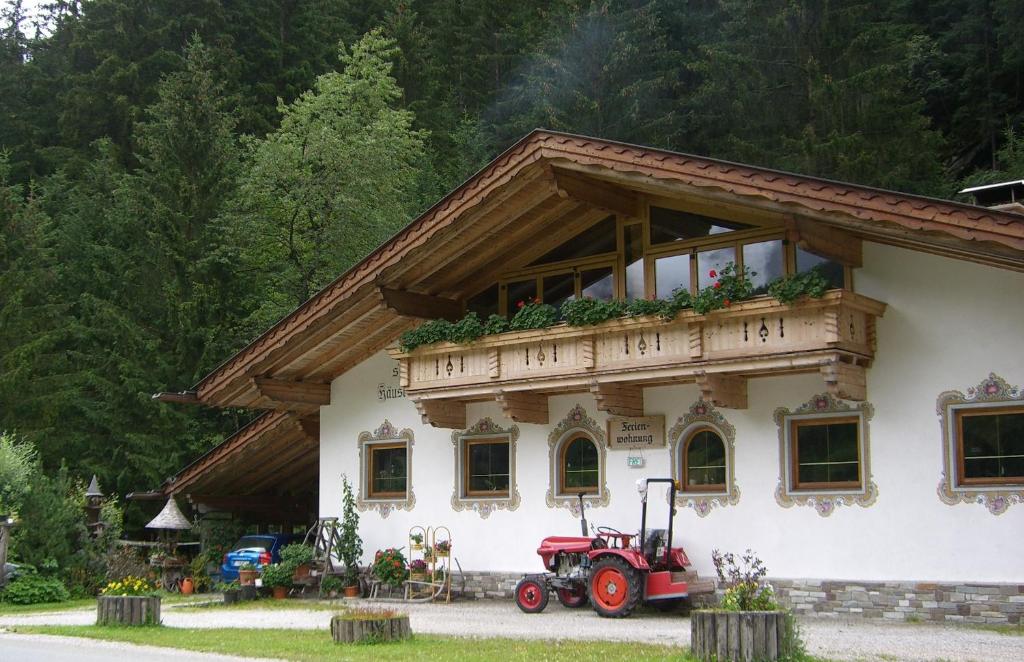 a tractor parked in front of a building at Jagahäusl in Neustift im Stubaital