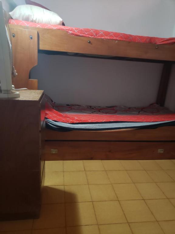 a bottom bunk of a bunk bed with a red mattress at DaKa in San Bernardo