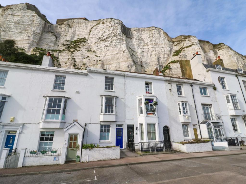 a white building in front of a mountain at 7 Athol Terrace in Dover
