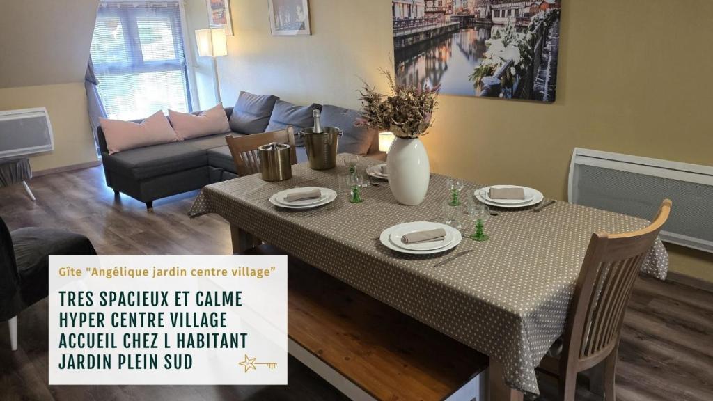 a living room with a table and a couch at Grand Gite Angelique avec Jardin - Centre Ribeauvillé in Ribeauvillé