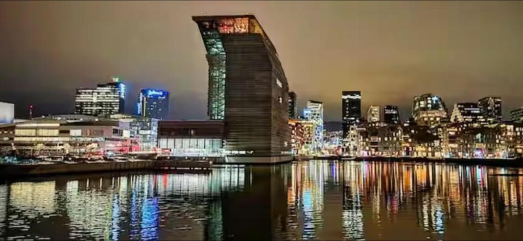 a view of a city at night with a building at Apartment Aker brygge- Oslo sentrum in Oslo