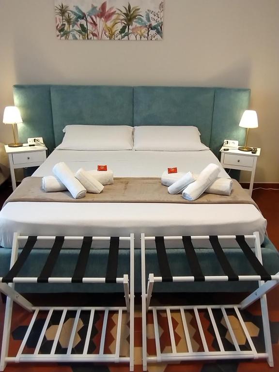 a bed with white sheets and pillows on it at Le Camere di Suleima in Messina