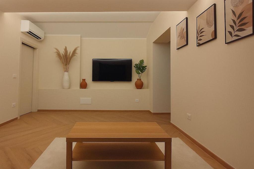 a living room with a table and a tv at La Casa di Vale in Ventimiglia