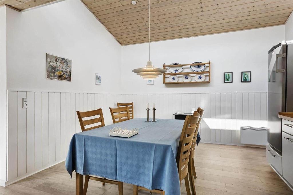 a dining room with a blue table and chairs at 13383-Asnaes-Glentevej-15 in Asnæs