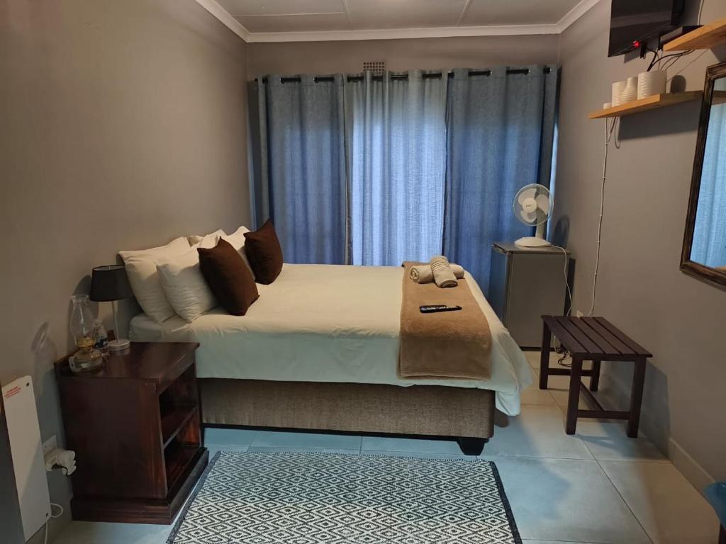 a bedroom with a large bed and a window at Spring Day in Piet Retief