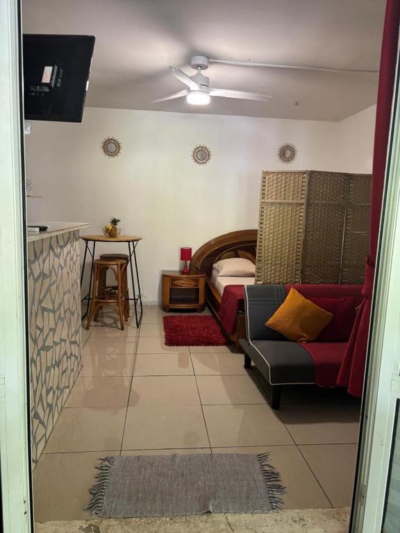 a living room with a couch and a bed at Domaine de Locastel 2 in Morne-à-lʼEau