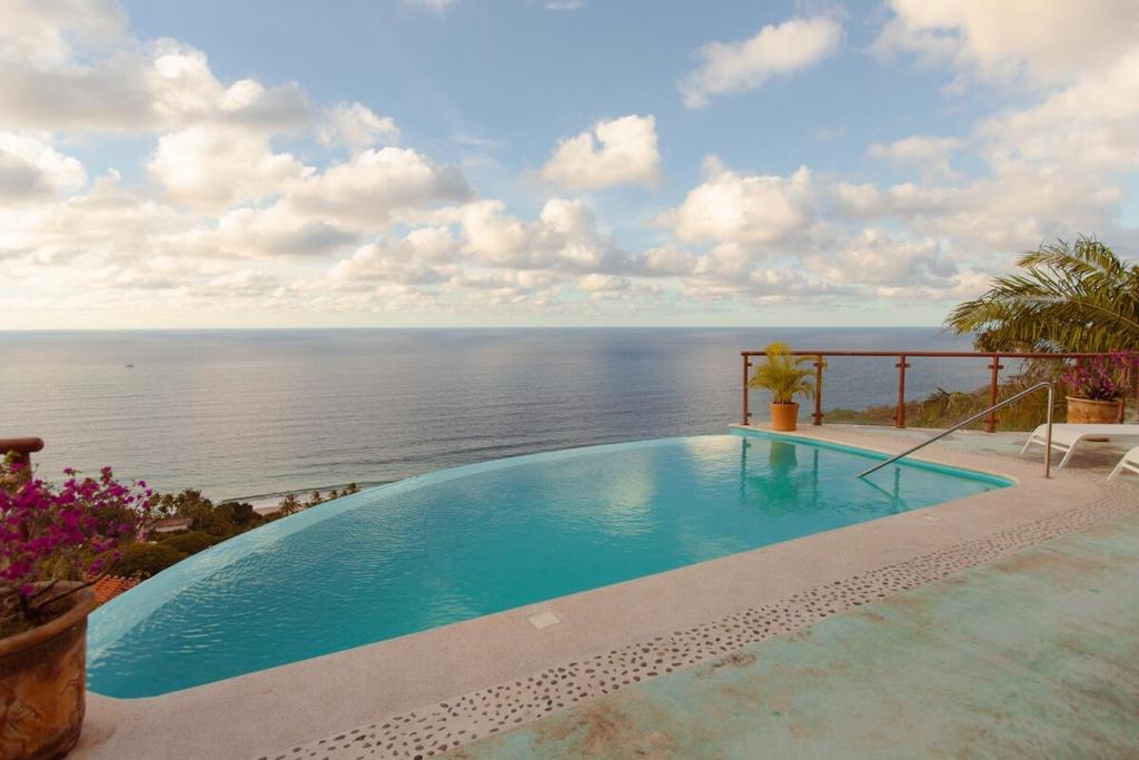 a swimming pool with a view of the ocean at Private Cliffside Villa with Infinity Pool in Sayulita