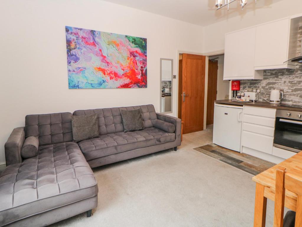a living room with a couch and a kitchen at Abraham in Matlock