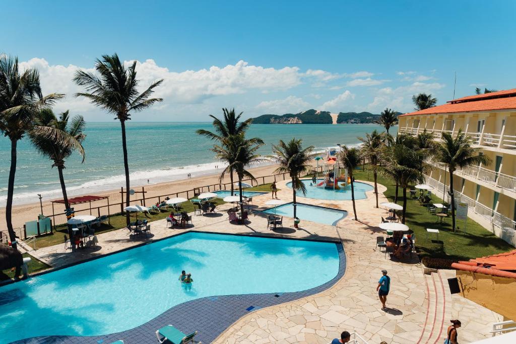 a view of a swimming pool and the beach at El Aram Natal Mar in Natal