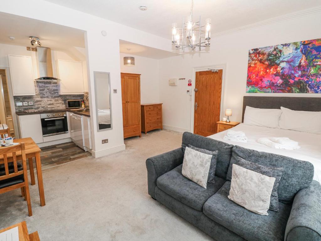 a living room with a bed and a couch at Arkwright in Matlock