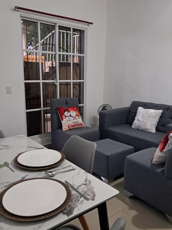 a living room with two couches and a table at Mario Aparta Estudio in San Felipe de Puerto Plata