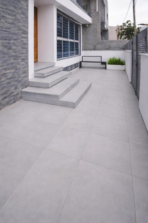 a patio with a bench in front of a building at Salt & Sand T3 in Praia