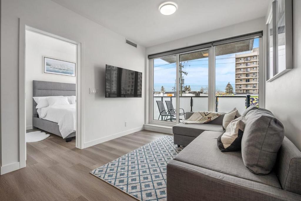 a living room with a couch and a bed at Stylish Serenity 1BR Kensington Condo wParking in Calgary