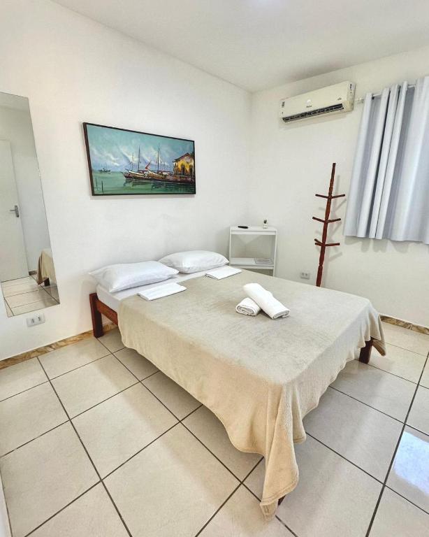 a bedroom with a bed with two towels on it at Quarto 02 - Pousada Canaã in Recife